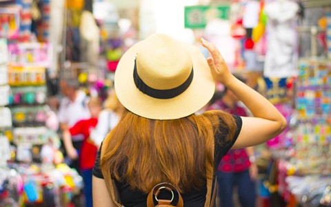 A woman wearing a hat on a Hong Kong street