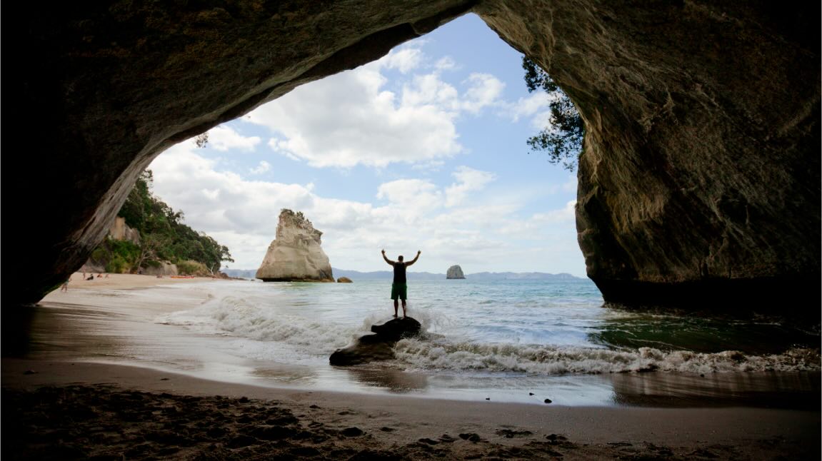 A person standing in Cathedral Cove